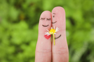 Man is giving flowers to a woman